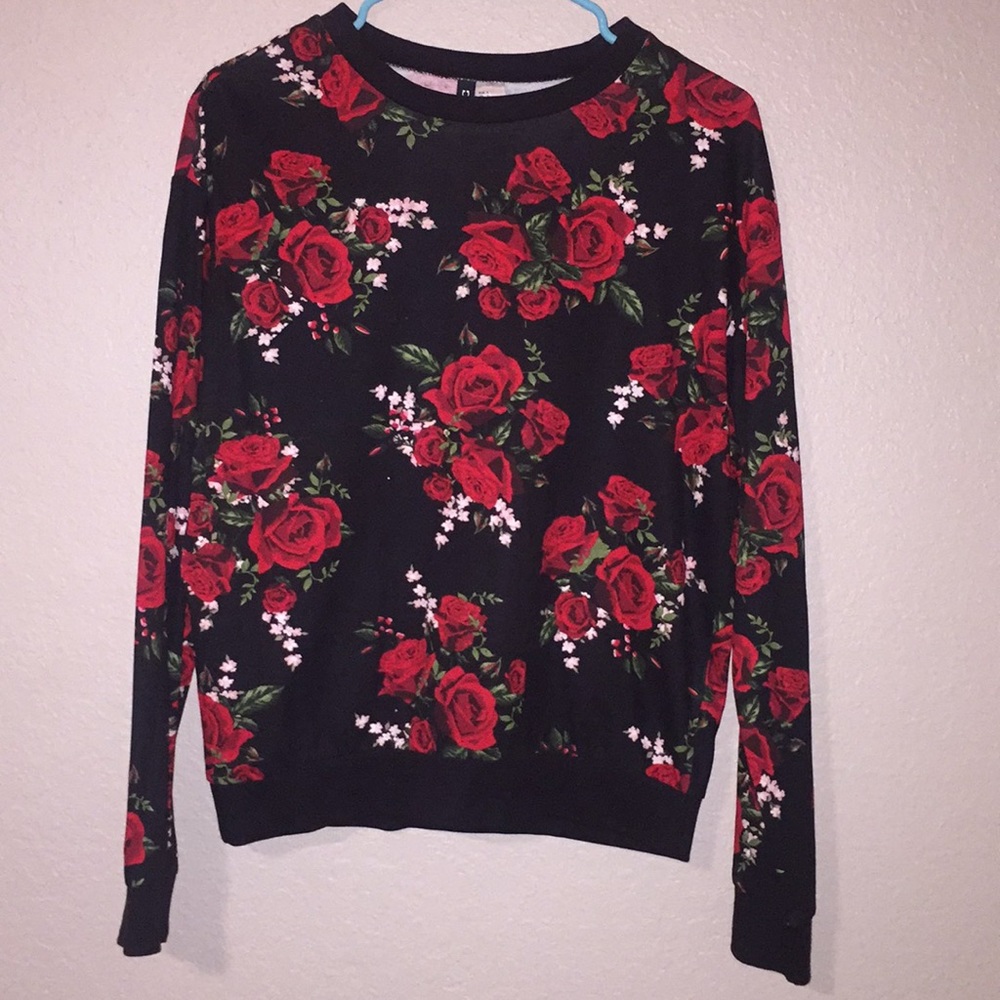 Black sweater, covered in red roses.